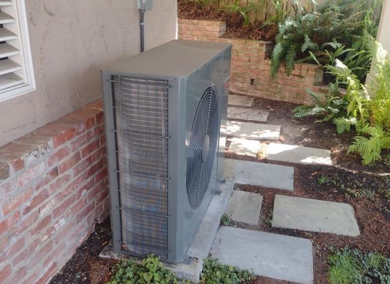 heat pump outdoor unit outside a home